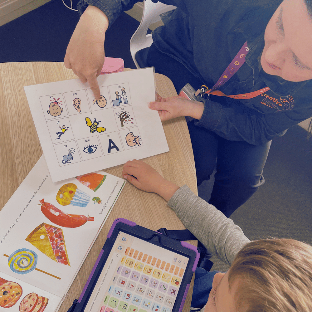 Speech pathologist supporting a child with communication activities