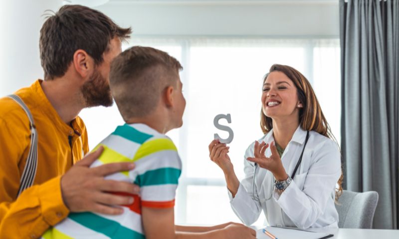 Speech pathologist working alongside a parent and child to support communication.