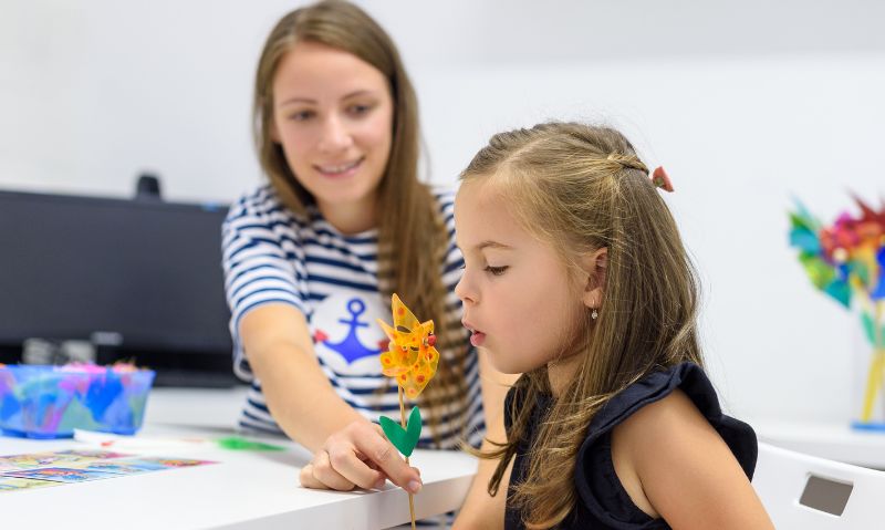 Therapist using play-based activities to support a childās communication skills.