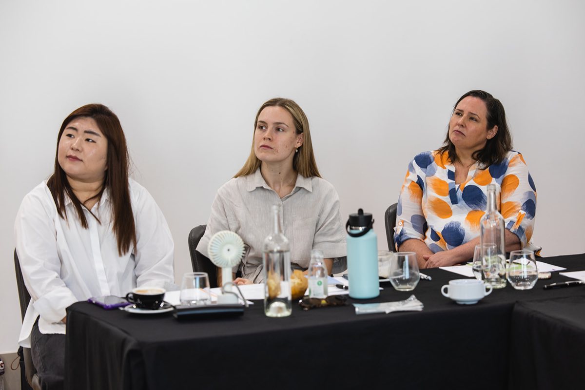 Three Creative Therapy Adelaide team members listening during a team discussion