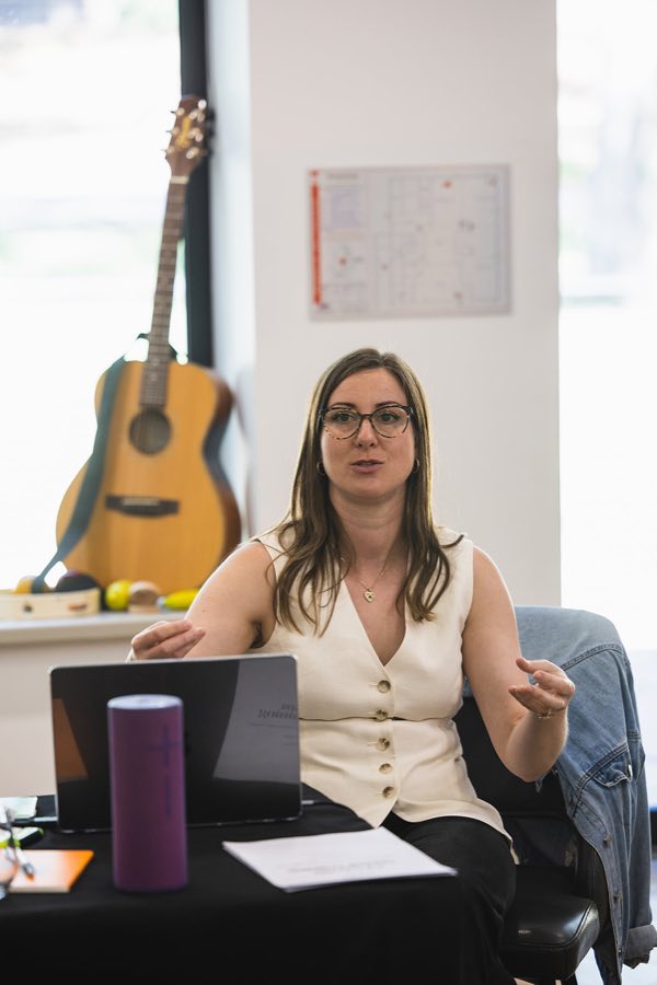 A Creative Therapy Adelaide team member sharing ideas during a team discussion